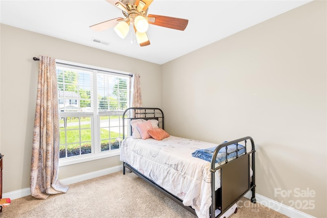 bedroom with ceiling fan, baseboards, carpet flooring, and visible vents