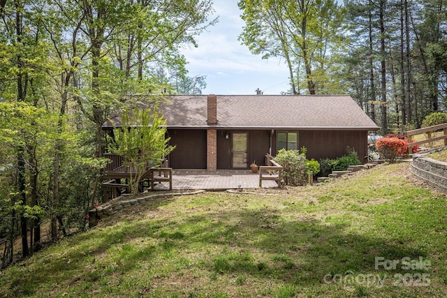 605 Hennessee St, Morganton, NC 28655 - rear view of property featuring a chimney and a wooden deck