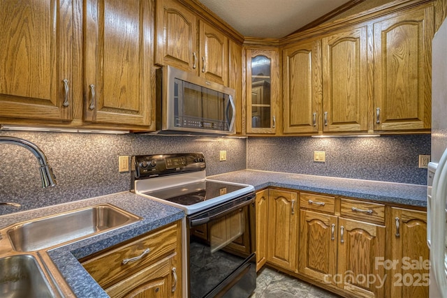 605 Hennessee St, Morganton, NC 28655 - kitchen featuring stainless steel microwave, range with electric stovetop, brown cabinets, a sink, and dark countertops