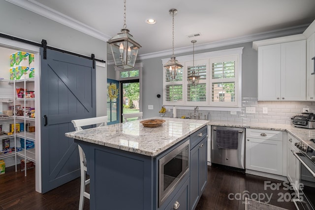 kitchen with white cabinets, visible vents, appliances with stainless steel finishes, and crown molding