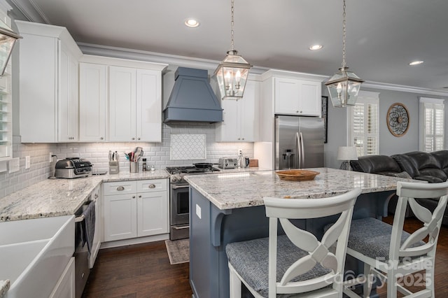 kitchen with backsplash, crown molding, appliances with stainless steel finishes, and custom exhaust hood