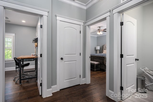 hallway with recessed lighting, dark wood finished floors, crown molding, and baseboards