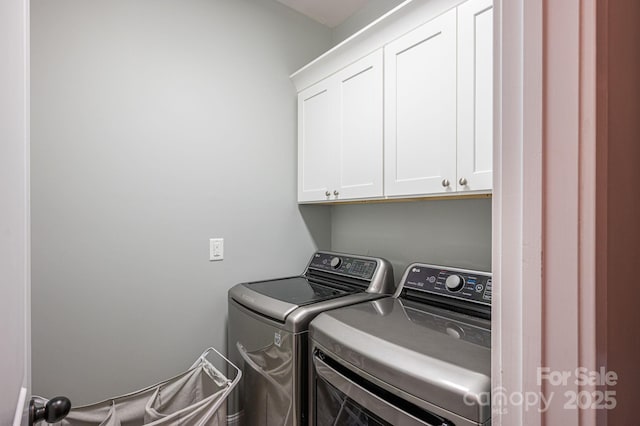laundry area with washer and clothes dryer and cabinet space