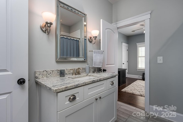 full bathroom featuring baseboards, vanity, and a shower with shower curtain