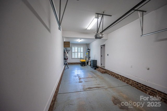 garage with water heater and a garage door opener