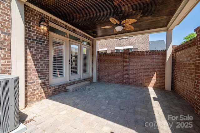 view of patio / terrace with fence, a ceiling fan, and central AC