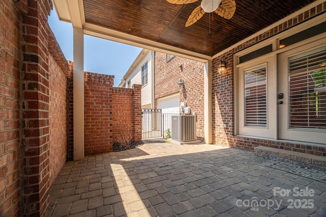 view of patio / terrace featuring central AC unit, fence, and a ceiling fan