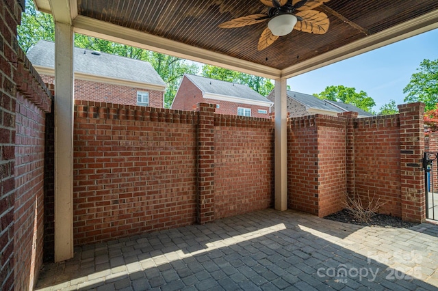 view of patio / terrace with fence and a ceiling fan