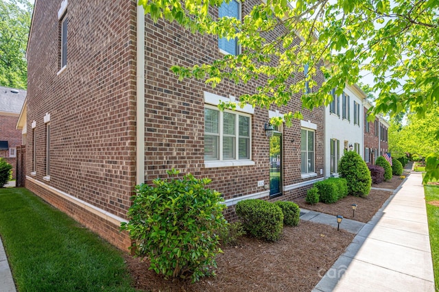 view of side of property with brick siding