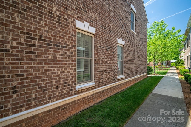 view of property exterior with brick siding