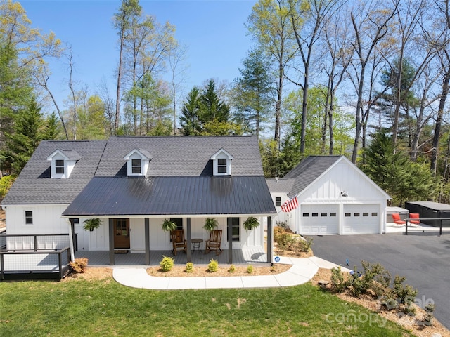 30 Gap Hill Dr, Fletcher, NC 28732 - view of front of property with covered porch, board and batten siding, an outbuilding, a front yard, and asphalt driveway