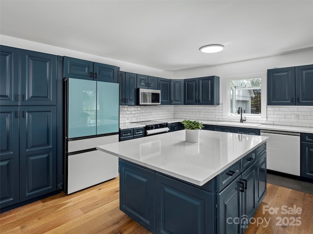 30 Gap Hill Dr, Fletcher, NC 28732 - kitchen with white fridge, stainless steel microwave, dishwasher, a center island, and light wood-style floors