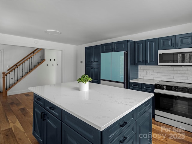 30 Gap Hill Dr, Fletcher, NC 28732 - kitchen featuring electric stove, paneled fridge, a kitchen island, dark wood finished floors, and light stone countertops