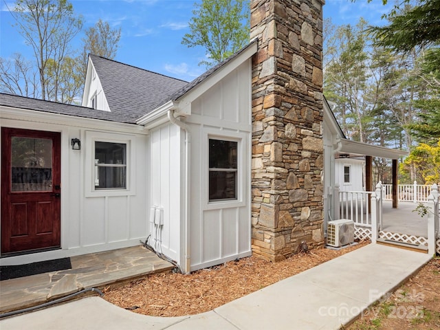 30 Gap Hill Dr, Fletcher, NC 28732 - view of exterior entry with board and batten siding, a shingled roof, a chimney, and covered porch
