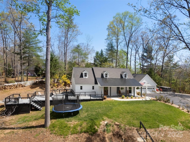 30 Gap Hill Dr, Fletcher, NC 28732 - back of property with a trampoline, a lawn, a deck, driveway, and a garage