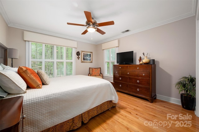 bedroom with light wood finished floors, crown molding, baseboards, and ceiling fan