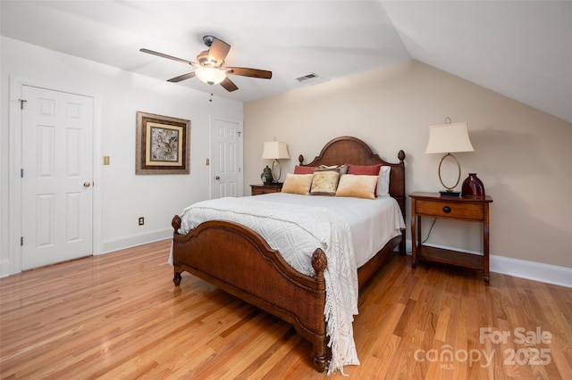 bedroom with light wood finished floors, baseboards, lofted ceiling, and ceiling fan