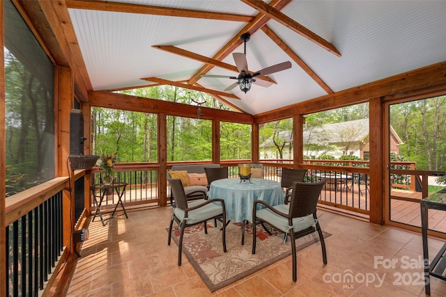 sunroom / solarium with a ceiling fan and outdoor dining space