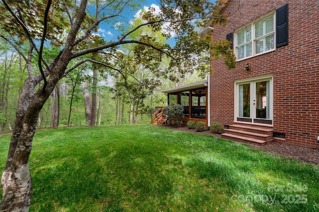 view of grassy yard with entry steps