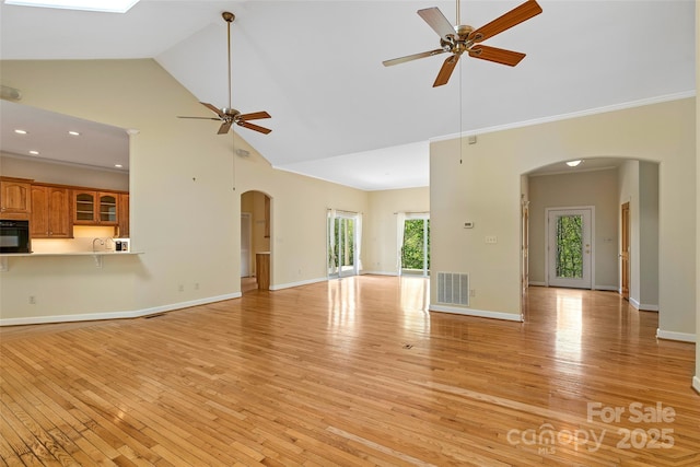 80 Ivy Cove Rd, Fairview, NC 28730 - unfurnished living room with high vaulted ceiling, ceiling fan, arched walkways, and visible vents