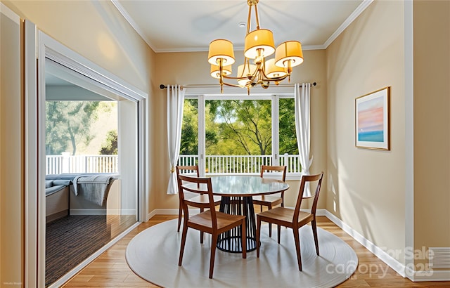 80 Ivy Cove Rd, Fairview, NC 28730 - dining room with a wealth of natural light, crown molding, a chandelier, and light wood-style flooring