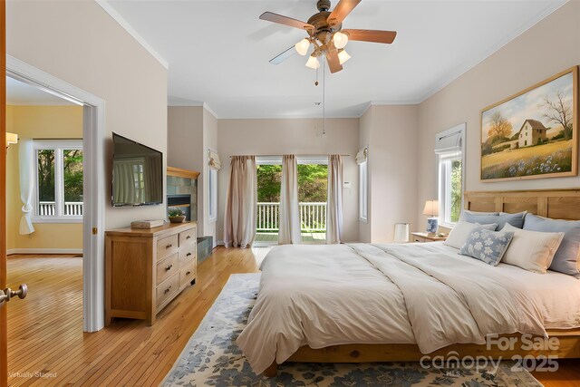 80 Ivy Cove Rd, Fairview, NC 28730 - bedroom with light wood-type flooring, access to outside, ornamental molding, and multiple windows