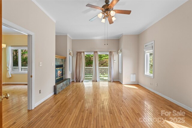 80 Ivy Cove Rd, Fairview, NC 28730 - unfurnished living room with a tile fireplace, baseboards, and crown molding