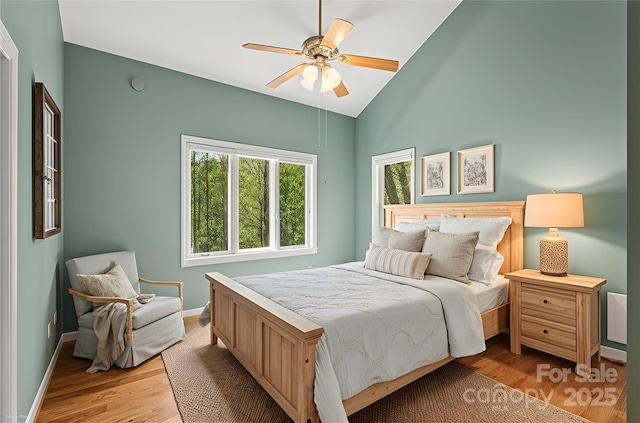 80 Ivy Cove Rd, Fairview, NC 28730 - bedroom featuring vaulted ceiling, light wood-type flooring, and baseboards
