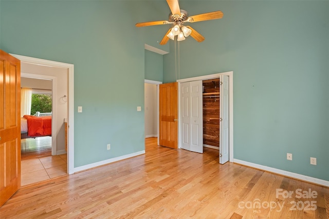 80 Ivy Cove Rd, Fairview, NC 28730 - unfurnished bedroom with a closet, a high ceiling, light wood-style flooring, and baseboards
