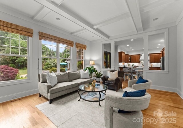 sunroom / solarium featuring beamed ceiling, coffered ceiling, and visible vents