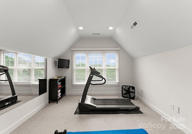 exercise room featuring baseboards, carpet floors, lofted ceiling, and visible vents