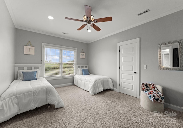 carpeted bedroom featuring visible vents, baseboards, and crown molding