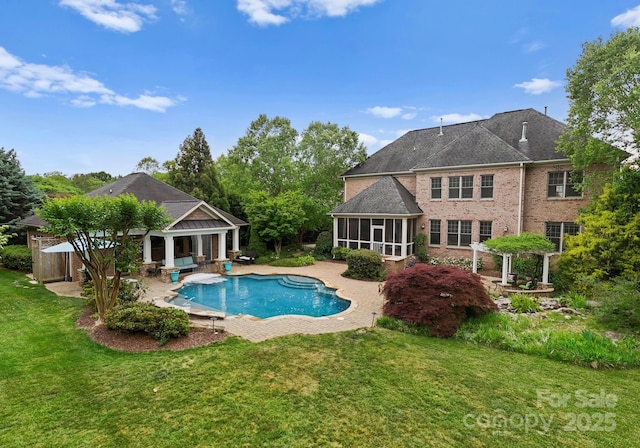 pool with a yard, a sunroom, and a patio area