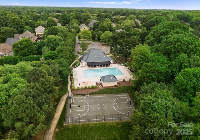 birds eye view of property with a wooded view