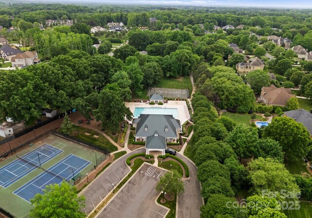 birds eye view of property with a view of trees
