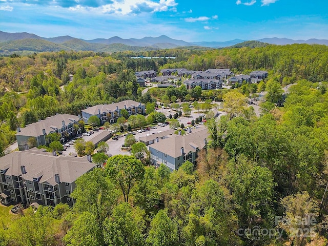 bird's eye view featuring a mountain view, a residential view, and a wooded view