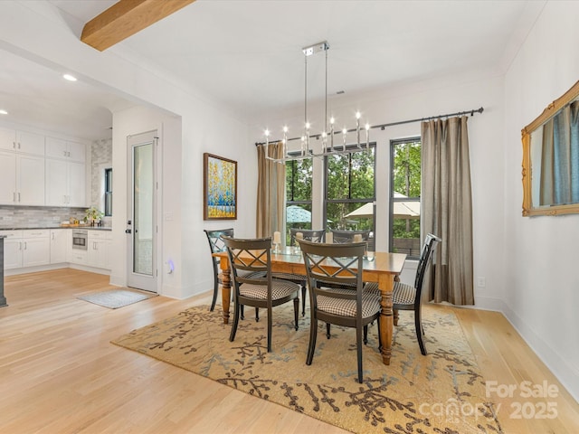 dining space featuring baseboards, a chandelier, light wood finished floors, and recessed lighting