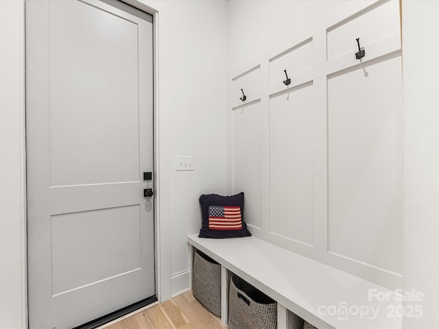 mudroom featuring baseboards and light wood-style floors
