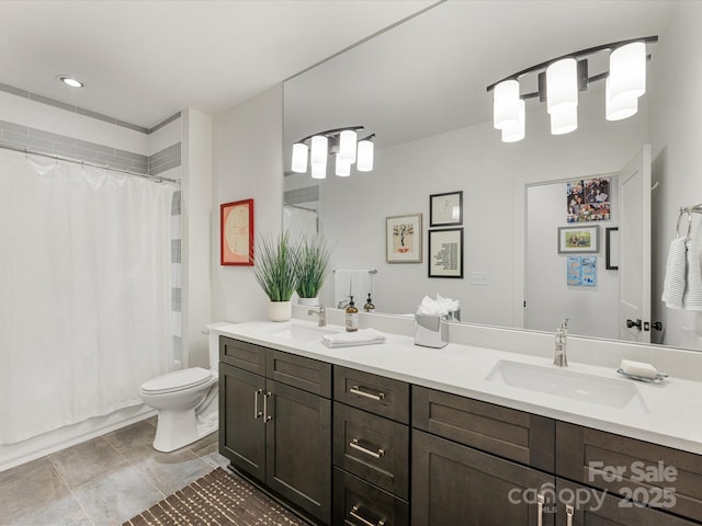 bathroom featuring shower / tub combo, toilet, a sink, and double vanity