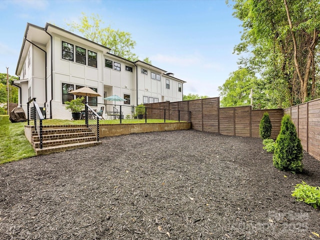 back of house featuring a fenced backyard
