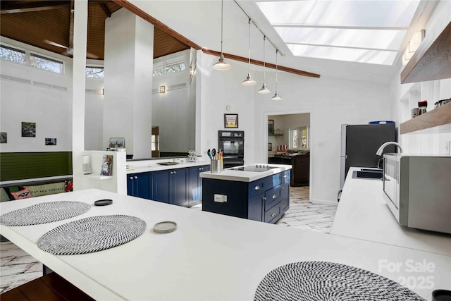 39 Tatham Rd, Hendersonville, NC 28792 - kitchen with blue cabinets, stainless steel microwave, a high ceiling, and marble finish floor