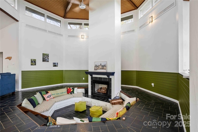 39 Tatham Rd, Hendersonville, NC 28792 - sunken living room with high vaulted ceiling, wood ceiling, a wainscoted wall, and a fireplace