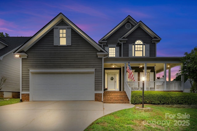 traditional-style house featuring a garage, a porch, and driveway