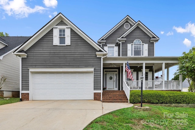 view of front of property featuring a porch, driveway, and a garage