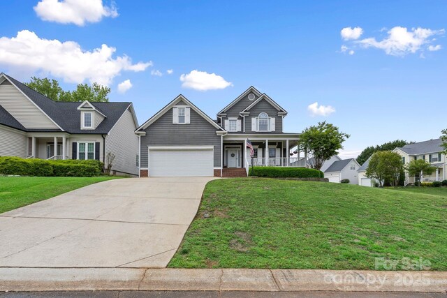view of front facade with covered porch, concrete driveway, and a front yard