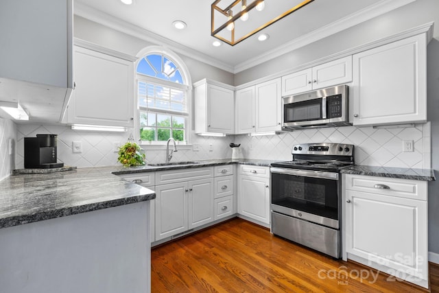 kitchen featuring white cabinetry, crown molding, a sink, stainless steel appliances, and dark wood finished floors