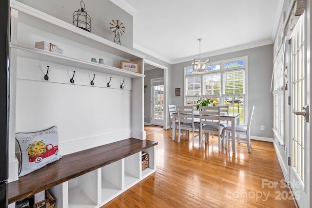 mudroom with crown molding, a notable chandelier, baseboards, and light wood-type flooring
