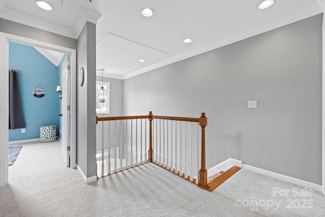 hall with crown molding, an upstairs landing, carpet flooring, and baseboards