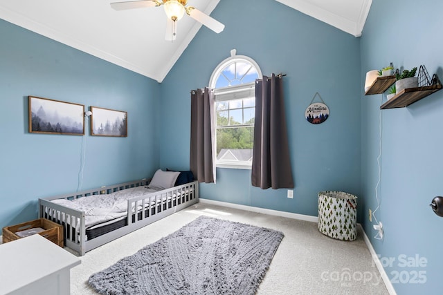 bedroom with crown molding, baseboards, carpet floors, vaulted ceiling, and a ceiling fan
