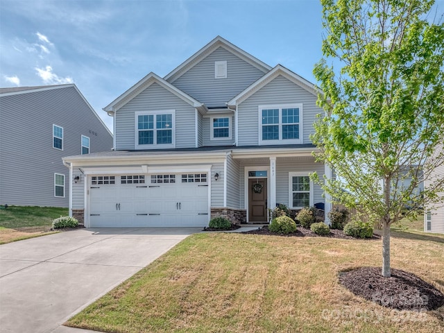 craftsman-style home featuring a garage, stone siding, a front lawn, and concrete driveway